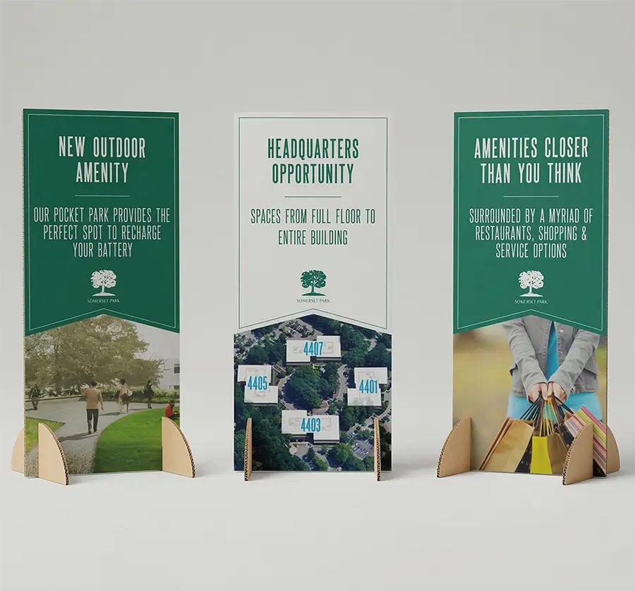 Large Format Printing 14 A portable, sustainable meter board sign with integrated recycled cardboard "winged" stands, isolated on a clean background.