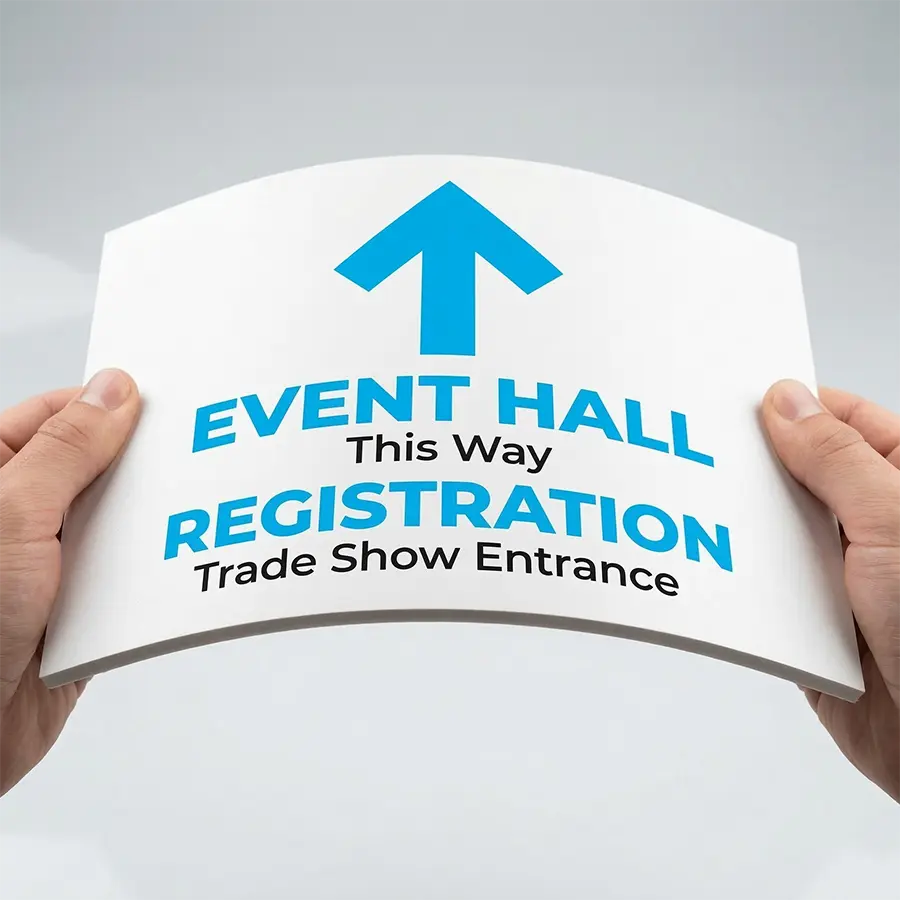 Flexible PVC Sintra Board (PVC) Signs A white PVC Sintra board being held and flexed by two hands, showing durability for event signage.
