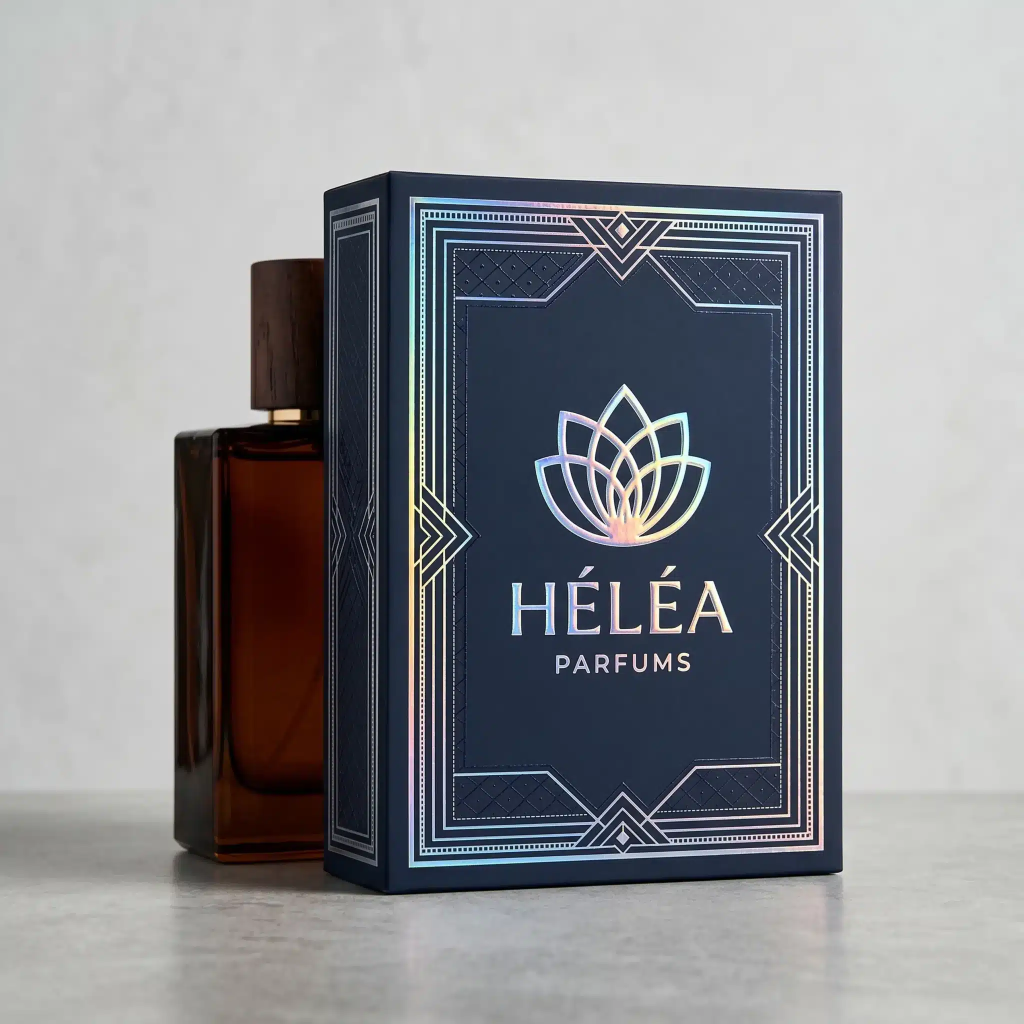 Scodix packaging embellishment, navy blue perfume box with iridescent metallic artwork Navy blue perfume packaging with iridescent metallic linework and the text “HELEA” and “PARFUMS” in reflective foil accents.