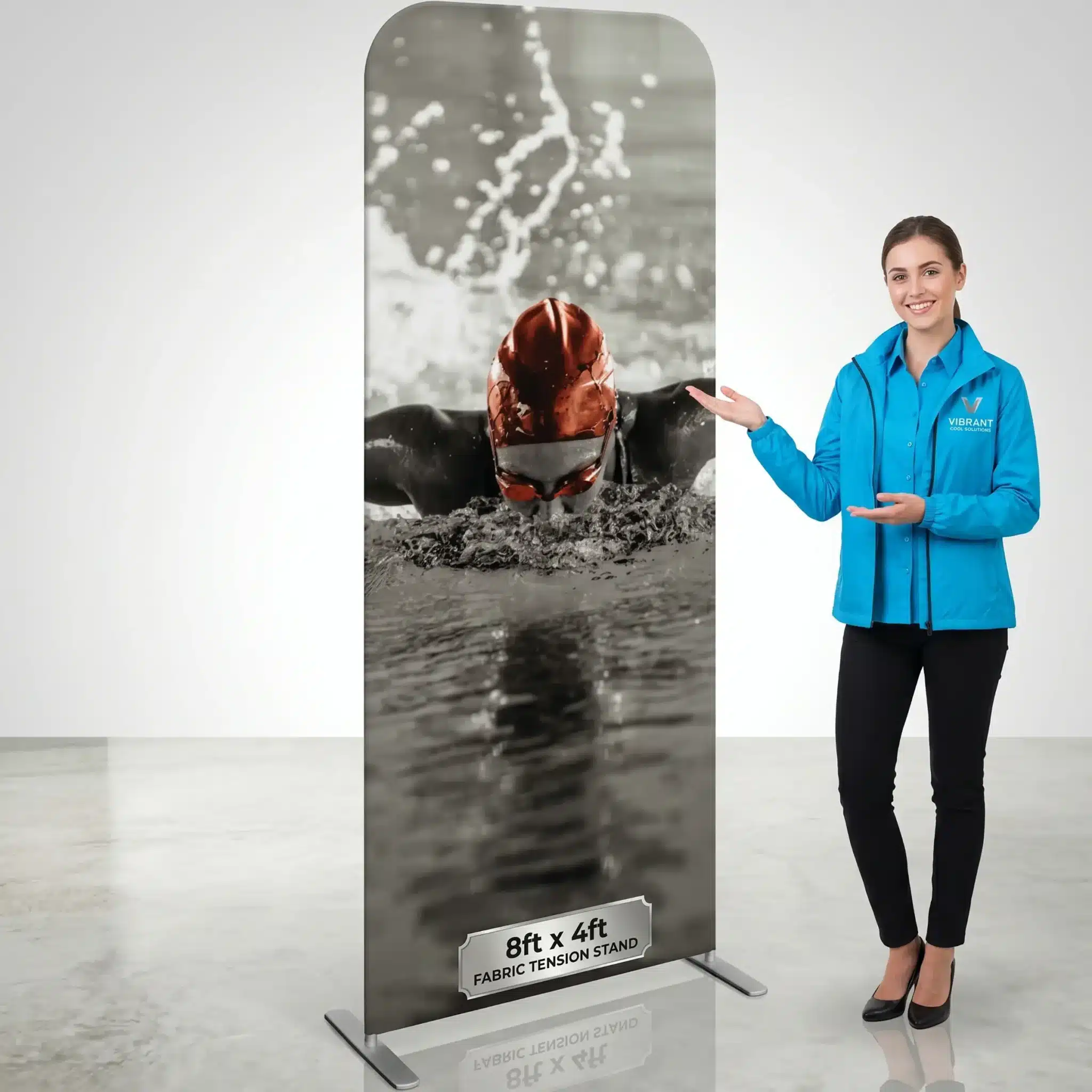 Pillowcase fabric backdrops NYC, 8ft x 4ft tension stand with presenter At a trade show display, a presenter stands beside an 8ft x 4ft Custom Pillowcase Fabric Backdrop NYC with vivid printed graphics.