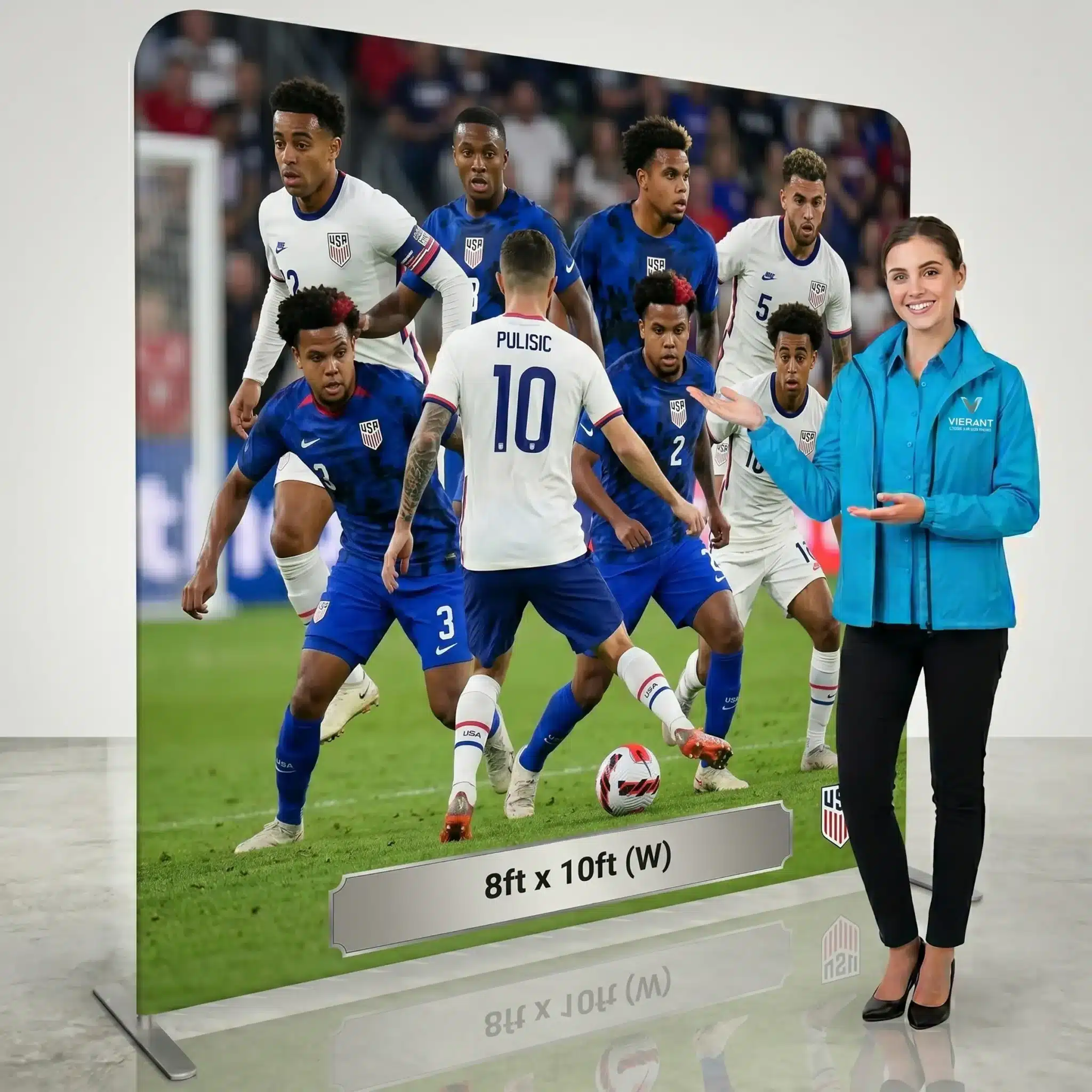 USA soccer fabric display backdrop, 8×10 foot Swift Pillowcase stand with presenter A presenter stands beside an 8x10 Swift Pillowcase fabric display stand showing a USA soccer lineup with Pulisic and other players.